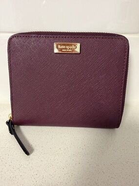 kate spade plum zip-around Saffiano wallet with gold plaque